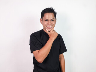 A cheerful young Asian man wearing a black casual shirt smiling confidently and posing on plain white background.