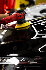 Car hood being polished with yellow pad. Paint polishing in active motion. Paint polishing to...