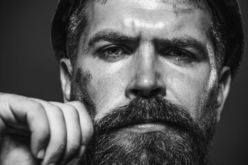 Closeup portrait serious architect, foreman or builder in hard hat. Handsome male engineer or...