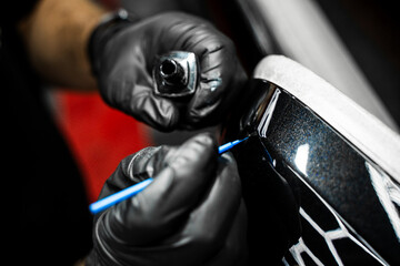 Touch-up paint applying to car chip using fine micro brush to prevent rust and restores the car...