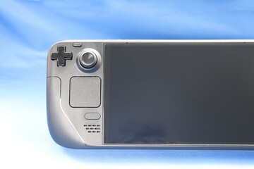 Portable game console on a blue background, close up, game console