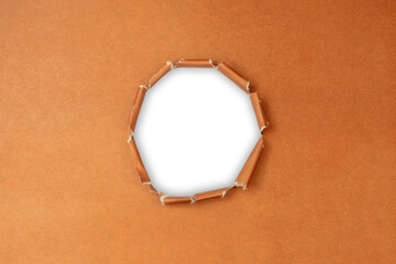 Torn Brown paper with a circular hole isolated a transparent background