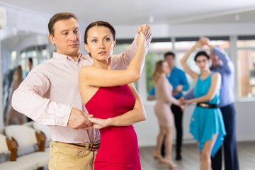 Adult couple dancing and practicing in dance class