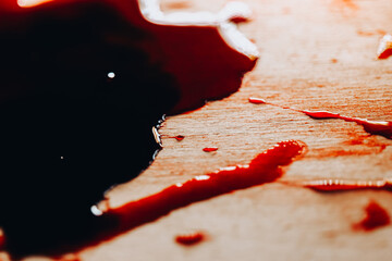 Red blood wallpaper.Criminal symbol.Halloween wallpaper.Abstract Red Liquid Spilled on...