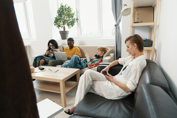Young woman socializing with colleagues and friends in a modern workplace, illustrating Gen Z...