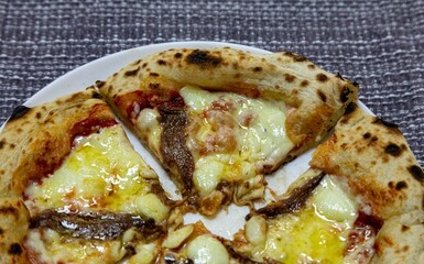 The most authentic Neapolitan pizza with anchovies, anchovies from the Mediterranean Sea, extra virgin olive oil and buffalo mozzarella cheese