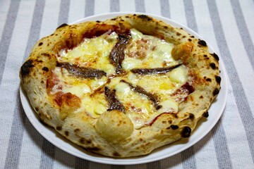 The most authentic Neapolitan pizza with anchovies, anchovies from the Mediterranean Sea, extra virgin olive oil and buffalo mozzarella cheese