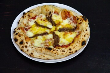 The most authentic Neapolitan pizza with anchovies, anchovies from the Mediterranean Sea, extra virgin olive oil and buffalo mozzarella cheese