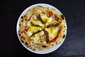 The most authentic Neapolitan pizza with anchovies, anchovies from the Mediterranean Sea, extra virgin olive oil and buffalo mozzarella cheese