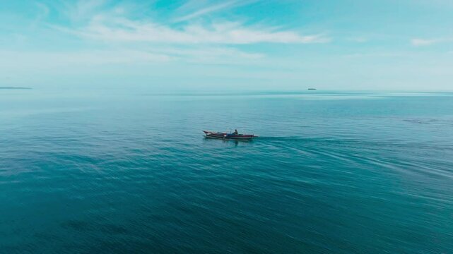 Aerial view of traditional Asian fishing boats in the middle of the ocean. Traditional Asian fishermen heading out to sea in the morning