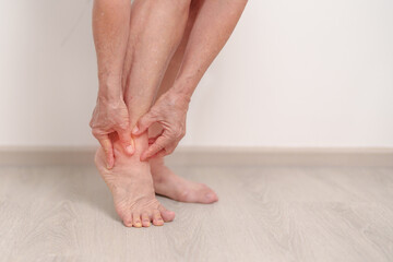 Elderly woman having leg pain due to Ankle Sprains or Achilles Tendonitis and Shin Splints ache....