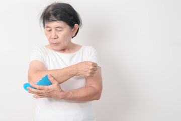 Elderly Woman having elbow ache and Edema with Cold Gel pack  for concepts of Tennis Elbow, muscle...