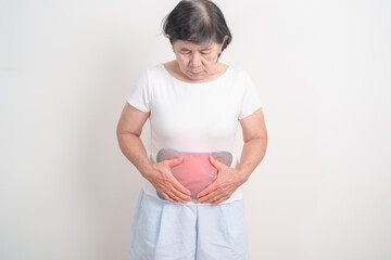 Elderly woman having abdomen aches with Hot Water Bottle Bag for Pain Relief for Stomach pain, digestion with constipation or Diarrhea from food poisoning, Stomachache and health care concepts
