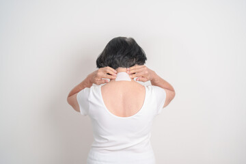 Elderly Woman having Neck pain with Medicated pain relief patch plaster for Neck Muscle Strain and...