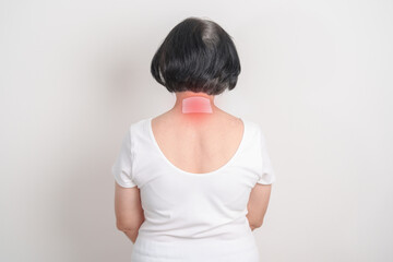 Elderly Woman having Neck pain with Medicated pain relief patch plaster for Neck Muscle Strain and...