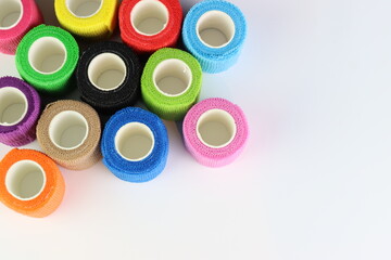 Different colors of cohesive bandages. Non adhesive bandage in a white background with different colors