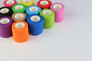 Different colors of cohesive bandages. Non adhesive bandage in a white background with different colors