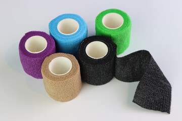 Different colors of cohesive bandages. Non adhesive bandage in a white background with different colors