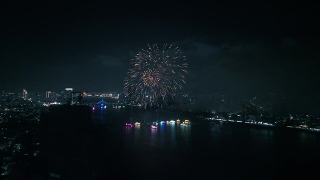 Vibrant fireworks bursting over han river, illuminating da nang's nightscape with dazzling colors and sparkling urban skyline