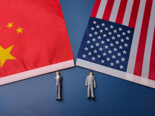 China and us flag with miniature people on a blue background