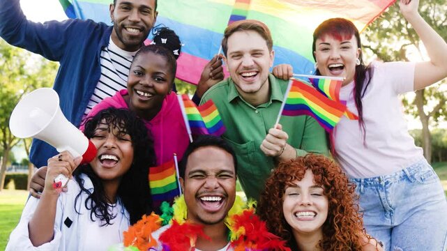 Diverse LGBTQ+ Gen Z friends celebrating with rainbow pride flags – Happy multiracial gay, lesbian, trans and non-binary youth enjoying outdoor festival together