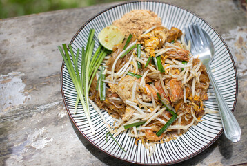 Pad Thai with fresh shrimp on a plate, close-up photo