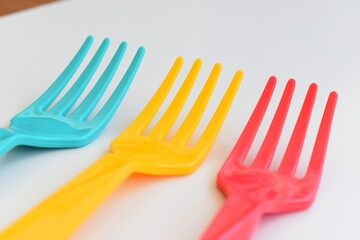 colorful fork isolated on white background, plastic cutlery for picnic