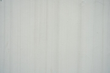 A light, off-white wall with subtle vertical streaks and a slightly weathered texture. Ideal as a...