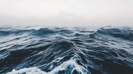 Misty sea with rhythmic waves conveys a sense of nature's vastness and power