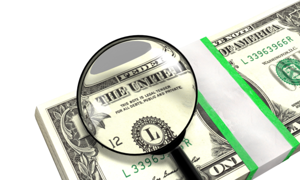 Magnifying glass inspecting the legal tender text on a stack of one us dollar bills on a transparent background.