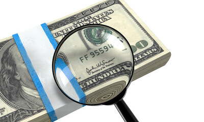 Magnifying glass inspecting the serial number on a stack of one hundred us dollar bills on a...