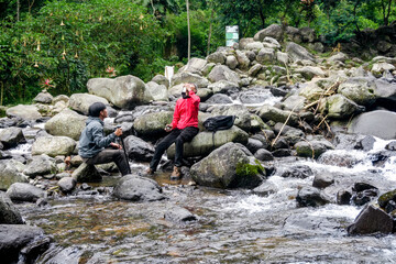 Portrait Of Two Hikers Resting After Walking And Have A Good Time Together