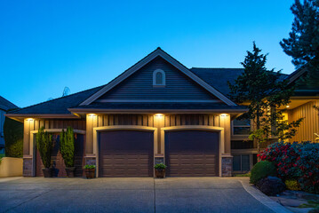 Garage door in luxury house with trees and nice landscape in Spring in Vancouver, Canada, North...