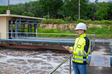 A wastewater treatment engineer is checking the treatment pond system to ensure that the water is...