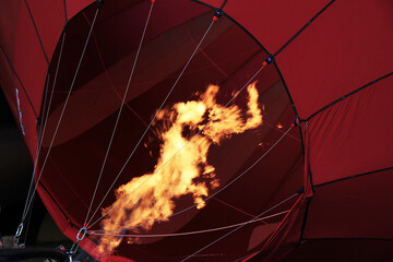 Close up of red hot air balloon burner flame. 