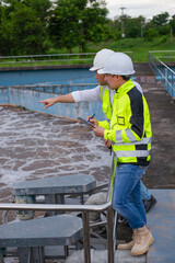 Wastewater treatment plant engineers are working together to check the water quality in the...
