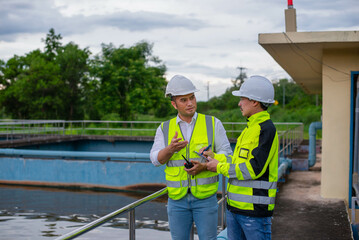 Wastewater treatment plant engineers are working together to inspect the wastewater treatment...