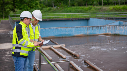 Wastewater treatment plant engineers are planning and discussing the installation of a new filtration system for a wastewater treatment plant.
