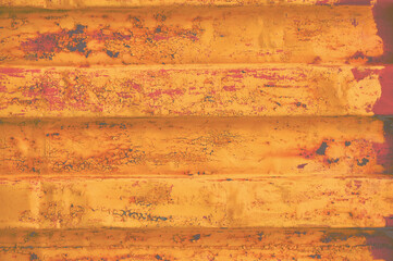 Yellow grunge sea freight container background, rusty corrugated pattern, red primer coating, horizontal rusted steel, grungy paint detail, old aged weathered textured rust metallic copy space closeup