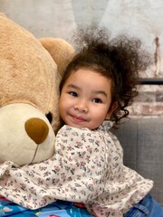 Portrait of a cute little girl with a teddy bear.