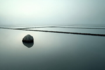 minimalist photograph of flooded rice paddy in india at sunrise with geometric patterns