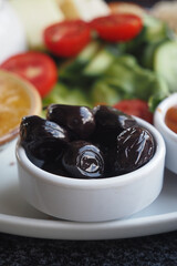 Fresh salad and olives served at a midday gathering