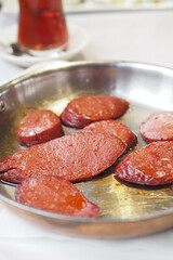 Sizzling sausages served in a classic metal pan