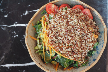 Healthy salad bowl with quinoa and fresh vegetables