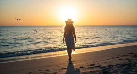 A woman in a dress walking on a beach at sunset with birds flying in the distance over the ocean