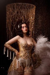 Young Caucasian circus performer or burlesque dancer in golden vintage corset, front view, posing...