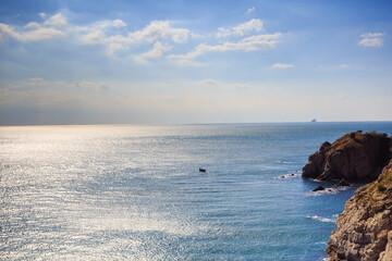 Calm blue sea and seaside rocks
