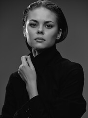 black and white portrait of a serious woman with short hair wearing a black turtleneck, elegant and...