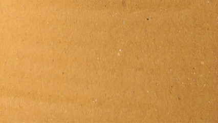 Background of brown kraft paper or cardboard texture. Old vintage paper with a glowing center and grunge vignette.