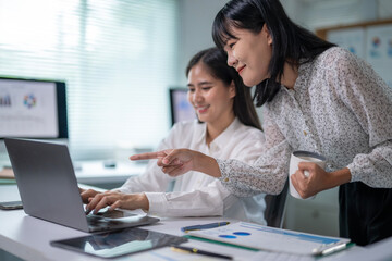 Fototapeta premium Two women are working on a laptop together